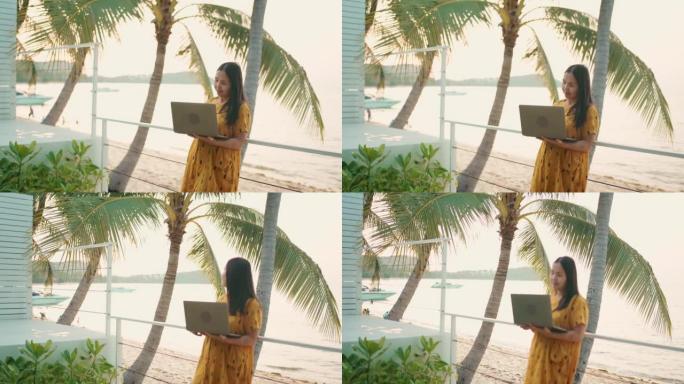 在泰国苏梅岛旅行时在笔记本电脑上工作的亚洲妇女。