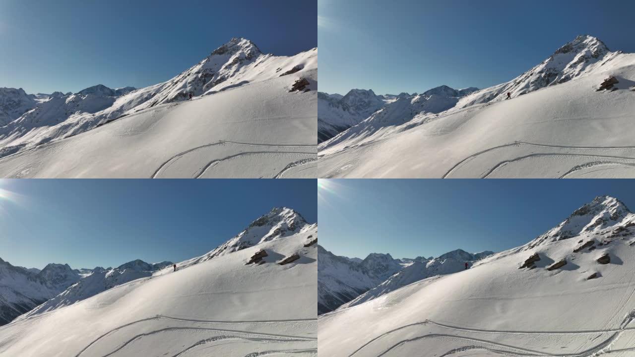 空中无人机拍摄了滑雪者在雪山上徒步旅行的镜头