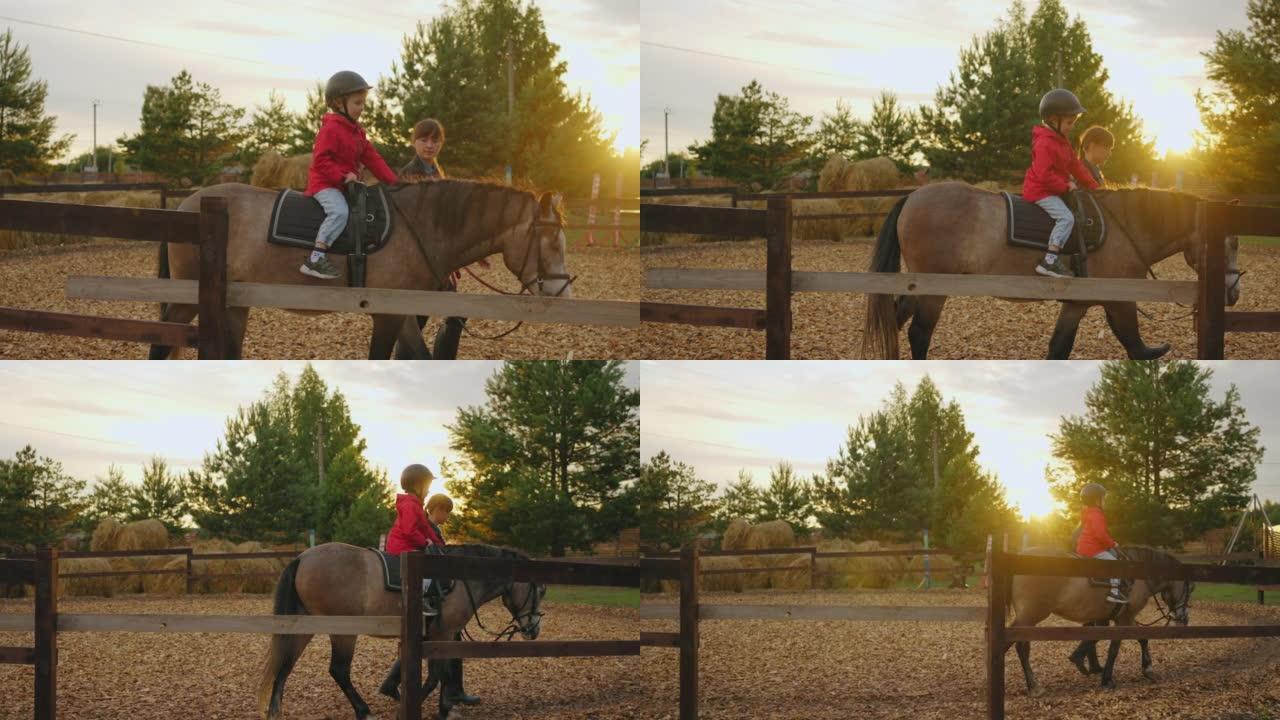 小马俱乐部的海马疗法和骑马疗法，小男孩和女教练在围场练习
