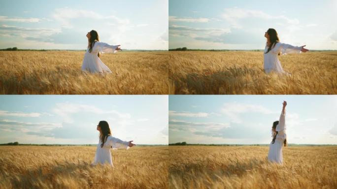 受启发的年轻女子在夏天独自走在金色的黑麦田上，欣赏农业景观