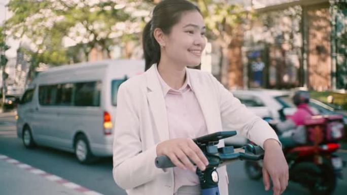 电动滑板车清洁能源，亚洲妇女使用清洁能源旅行商务旅行无污染。