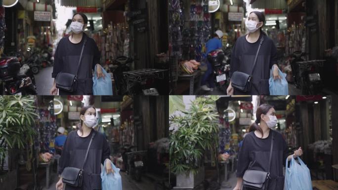 戴口罩的女人在街头市场购物