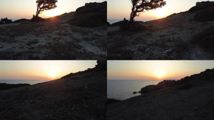 日落时地中海沿岸山坡和大海的鸟瞰图