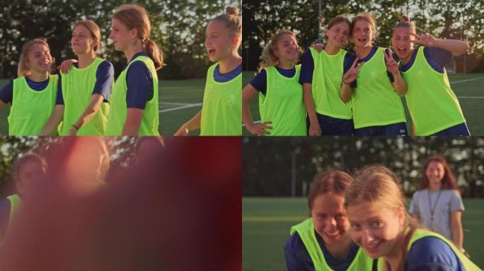 SLO MO年轻的女足球运动员笑着对着镜头玩得开心