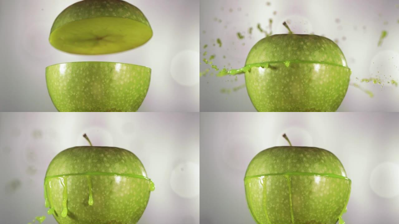 半个青苹果掉落并溅到白色背景上。食物悬浮概念。慢动作