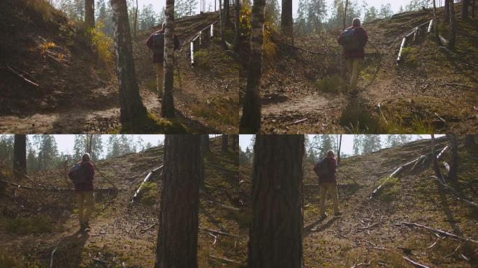 男人在秋天在森林里背包旅行，进行健康生活方式，呼吸新鲜空气和放松的运动