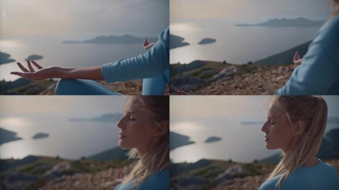 与自然的特写镜头。女人在海边落基山顶上的莲花姿势冥想