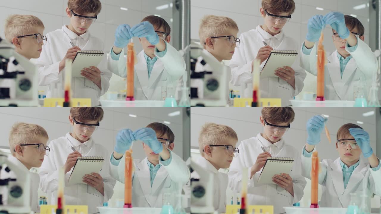 孩子们进行科学实验。实验室内部，混合泡沫，搅动液体