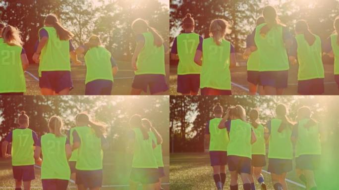 SLO MO TS女子足球队在实践中在阳光明媚的运动场上奔跑