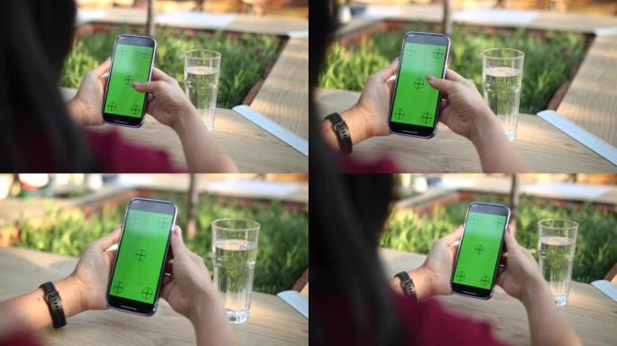 女交易员使用带有绿屏的智能手机