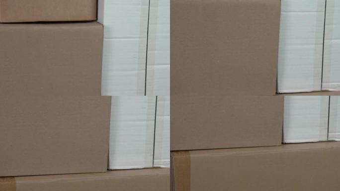 纸板送货箱。棕色和白色运输集装箱。纸垃圾