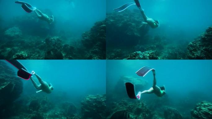 带鳍的自由潜水员在海洋水下滑行