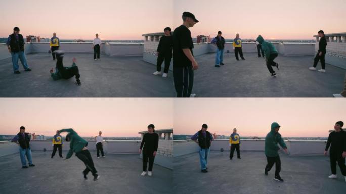 b-boy在屋顶上跳霹雳舞，在地板上旋转，表演技巧，青少年舞会