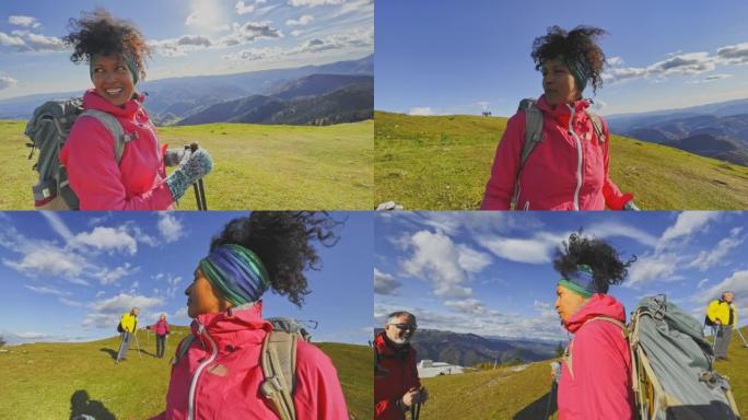 SLO MO女徒步旅行者在阳光明媚的山顶上与一名高级男徒步旅行者交谈