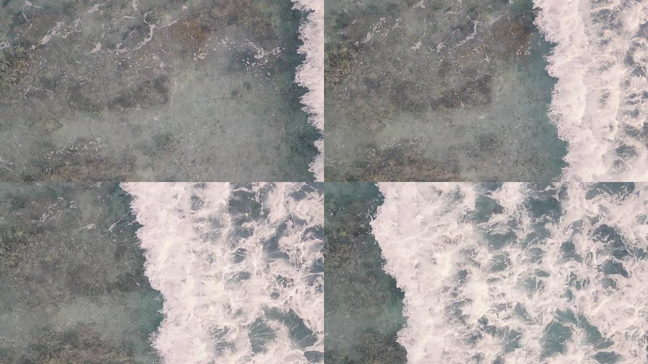空中无人驾驶飞机在岩石海岸上撞击海浪