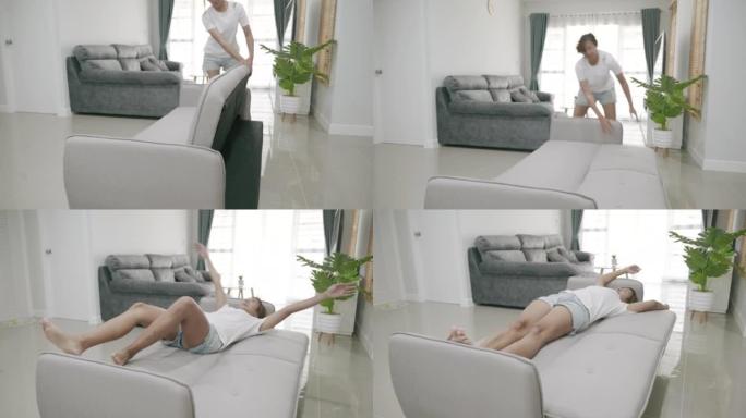 亚洲女人的场景对她从网上购物中购买的新沙发感到满意，亚洲女人睡在沙发上。快乐女性在客厅沙发上放松休息