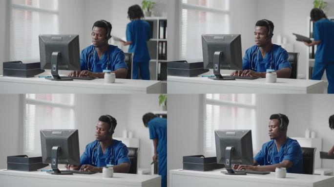 医生在线医疗咨询:非裔美国医生在台式电脑上与病人进行视频电话会议。