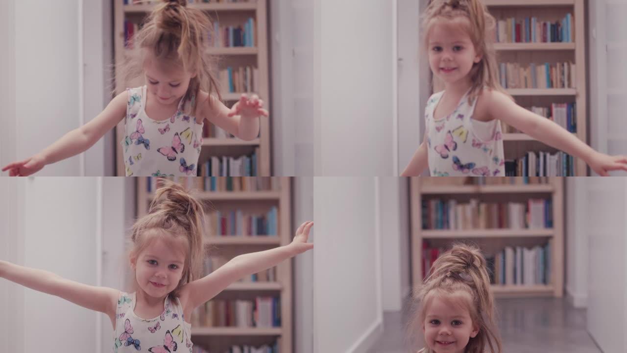 可爱的小女孩对着镜头跳舞微笑。家庭内部