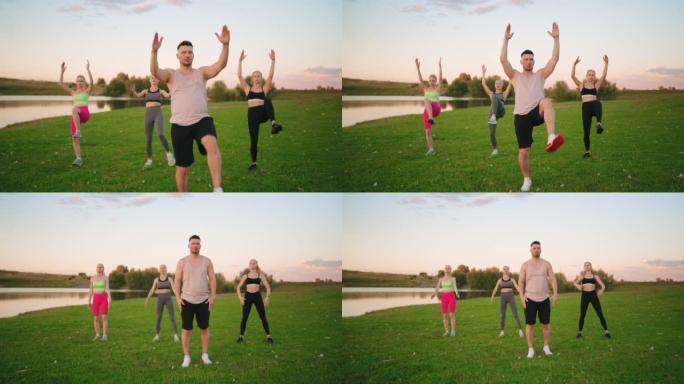 健身教练和三个运动美女在公园里练习瑜伽和普拉提，体育锻炼