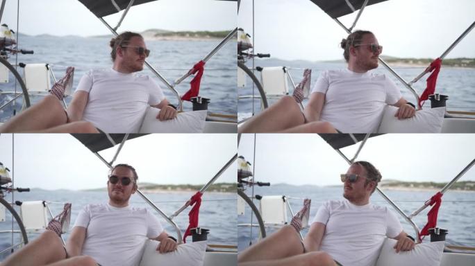 一个戴着墨镜的男人在帆船上放松的细节照片