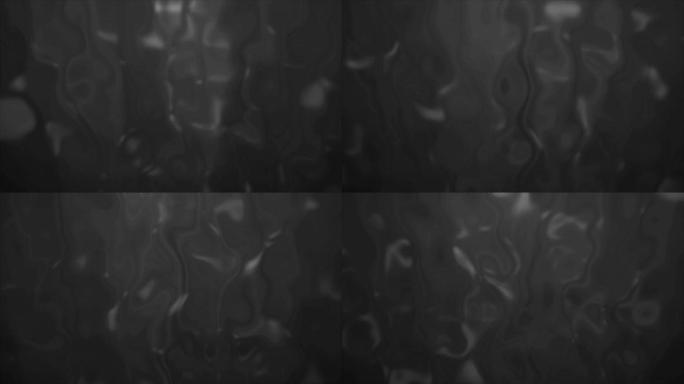 4k背景抽象模糊灰色，背景中发生液化。熔化彩色玻璃效果股票视频。缓慢溶解并流下液体抵抗光束