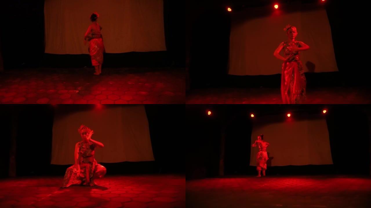 身穿传统服装的亚洲女子独自在红色灯光下跳舞