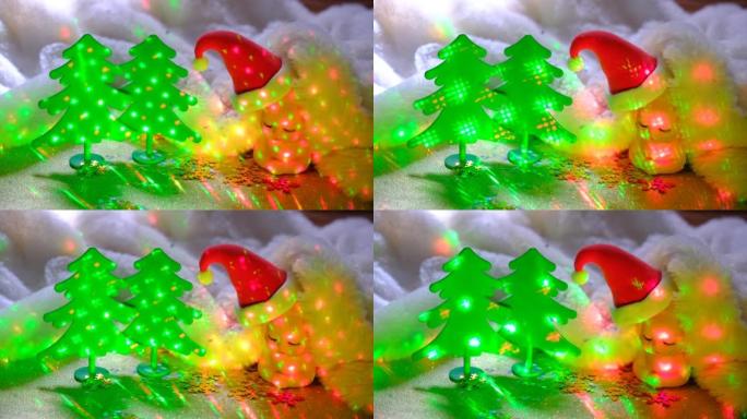 冬季仙女节日背景。可爱的玩具的圣诞气氛。像雪堆一样蓬松的折叠毯子中的小圣诞老人娃娃。闪烁的灯
