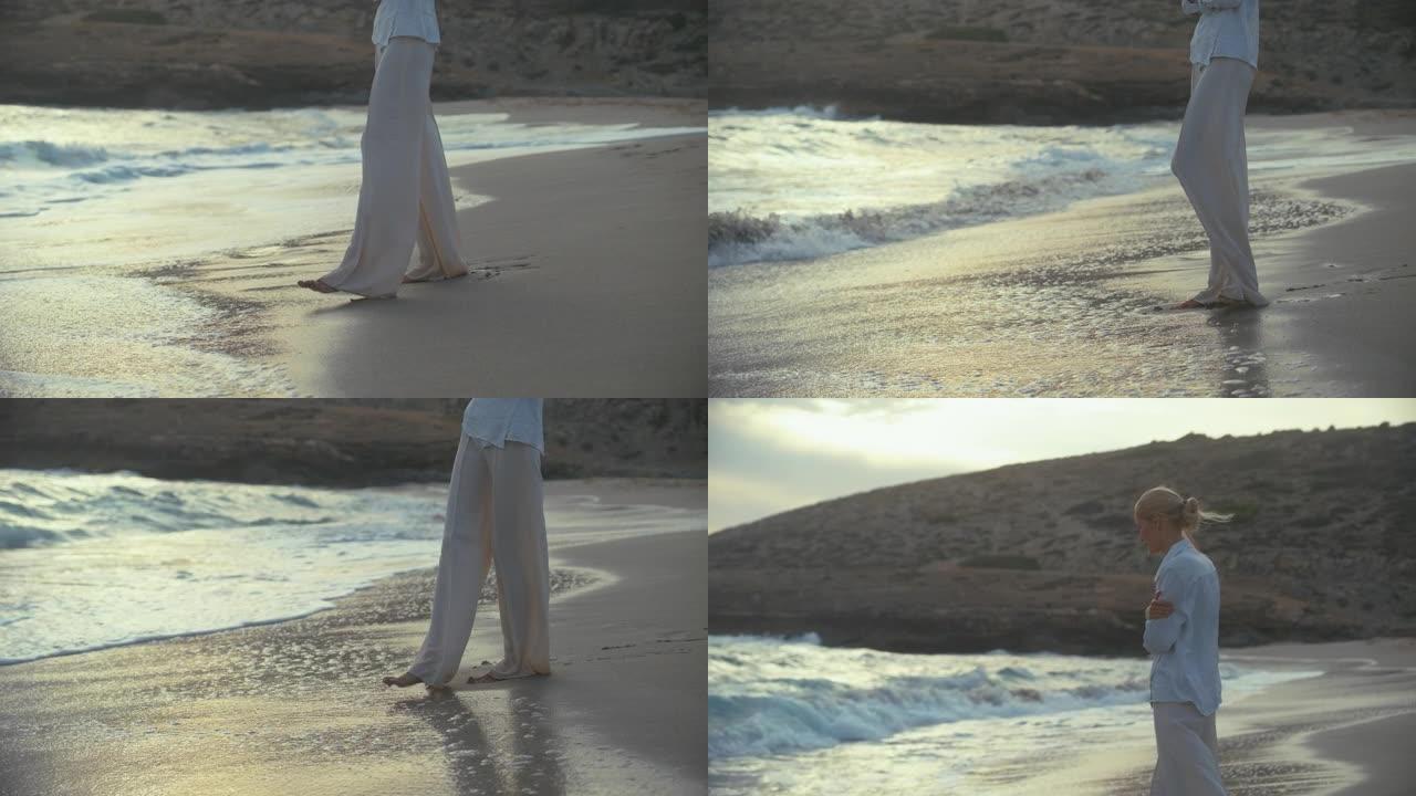 独自站在海滩上的女人。望着遥远的大海，赤脚感受沙子