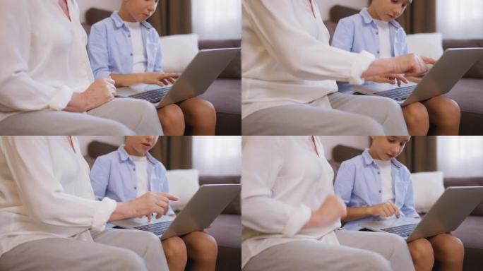 聪明的小男孩教奶奶使用笔记本电脑，现代技术