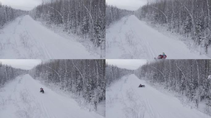森林里的冬季之路。夹。一条积雪很多的道路，一个人在冰杉树旁骑着电动雪猫