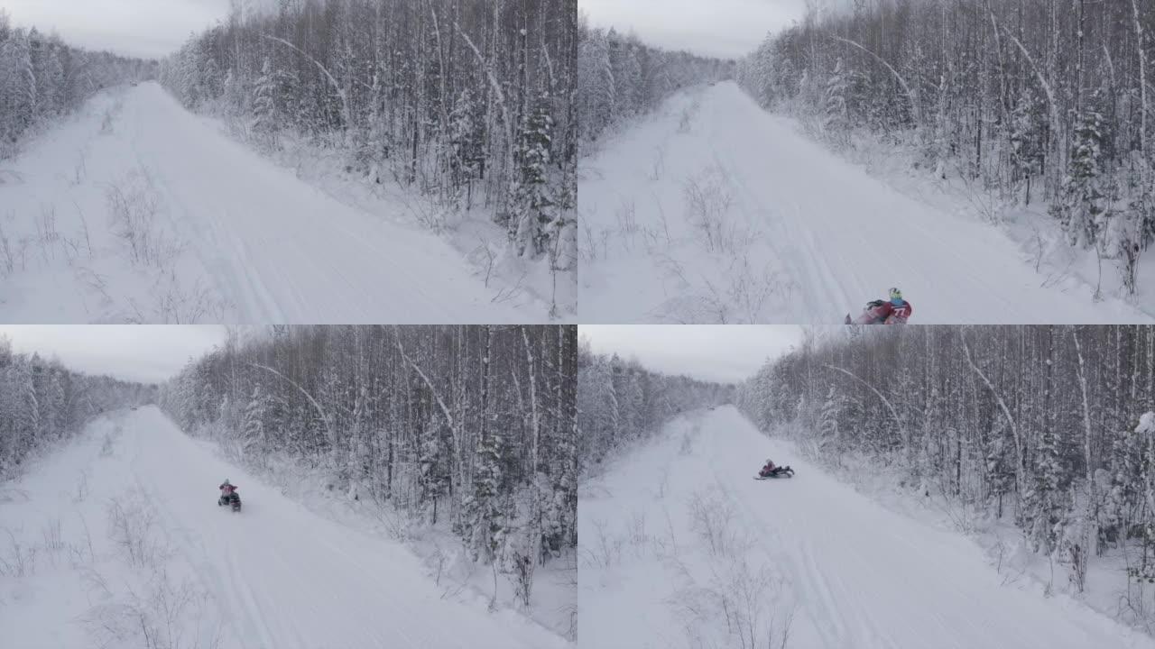 森林里的冬季之路。夹。一条积雪很多的道路，一个人在冰杉树旁骑着电动雪猫