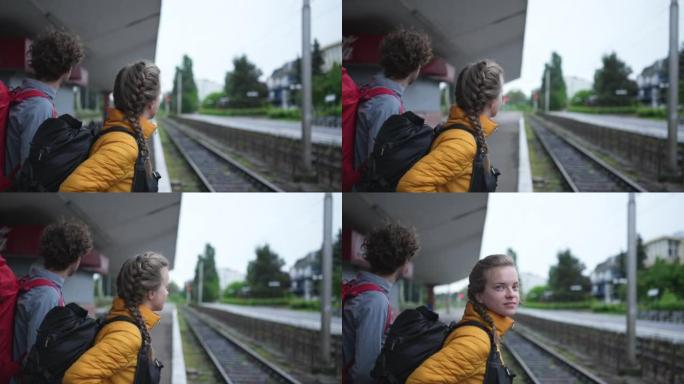 年轻夫妇走在火车轨道上，等待火车
