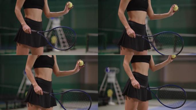 女人正准备将球送入网球比赛，训练或比赛，慢动作射击，身体细节