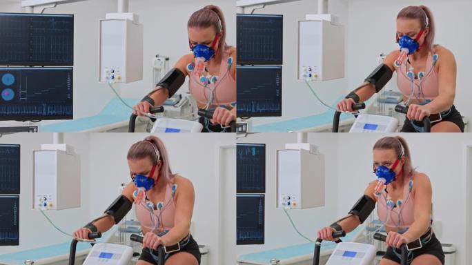 PAN Young女运动员在测力计上骑自行车，并在诊所进行肺功能测试