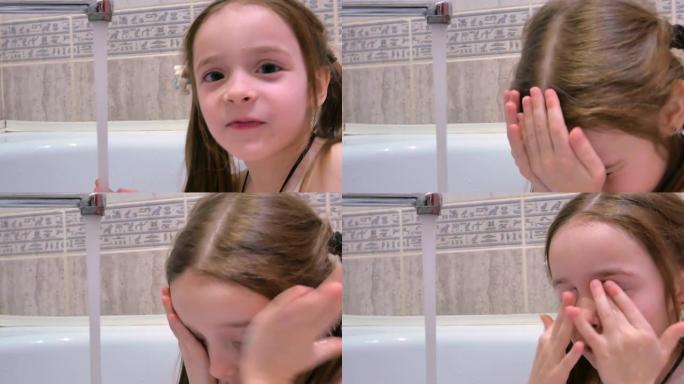 一个坐在浴室里的小女孩甜蜜地洗漱，手里拿着水，擦着脸和眼睛，头发湿漉漉的，衣衫不乱。儿童口腔卫生的概