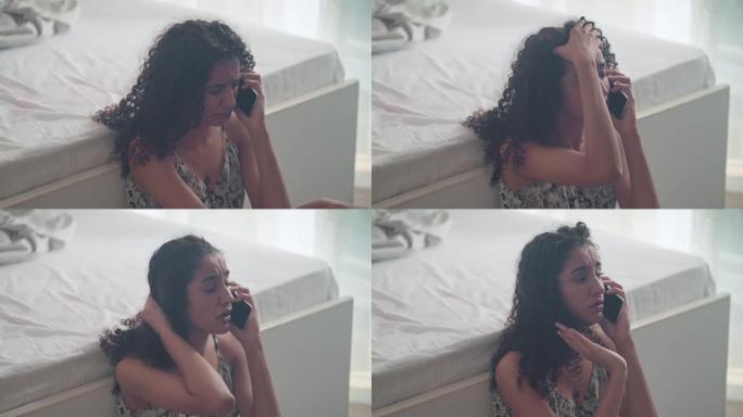 年轻的非洲裔美国伤心欲绝的妇女在手机通话中痛苦地哭泣