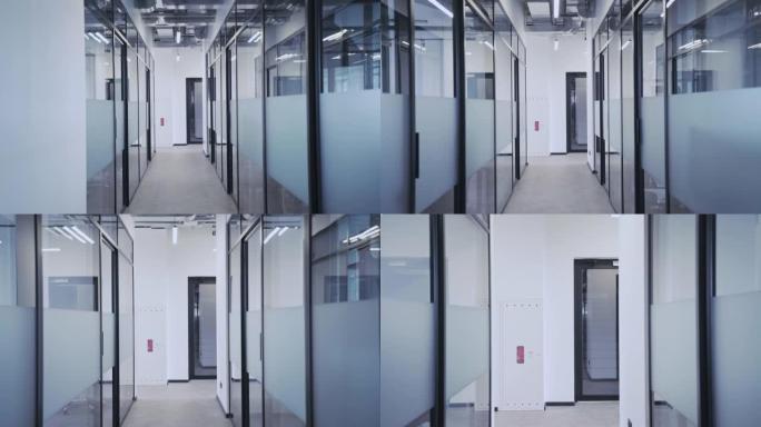 空荡荡的办公室走廊，玻璃墙和许多门，舒适的工作场所