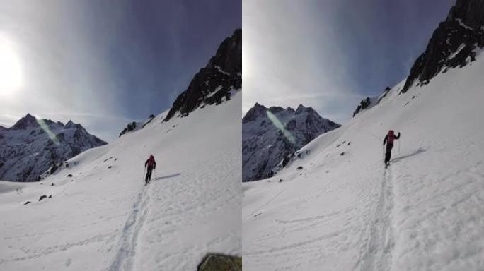 第一人称视角在阳光明媚的日子里在偏远的高山滑雪登山