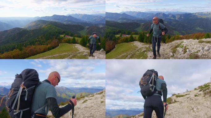 SLO MO男性徒步旅行者走在陡峭的小径上，欣赏美景