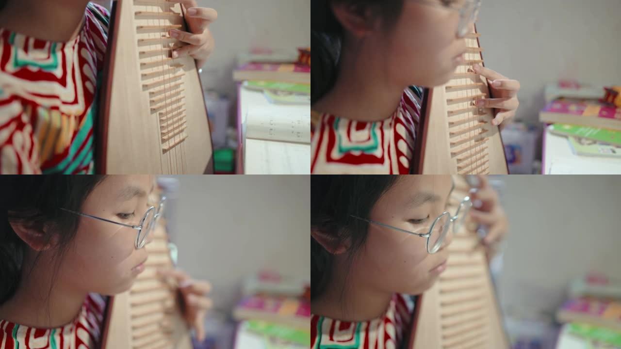 小女孩弹琵琶 (中国琵琶，一种带指板的弹拨弦乐器)