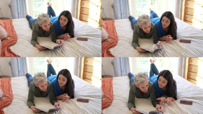 Mother and daughter reading a book together on the