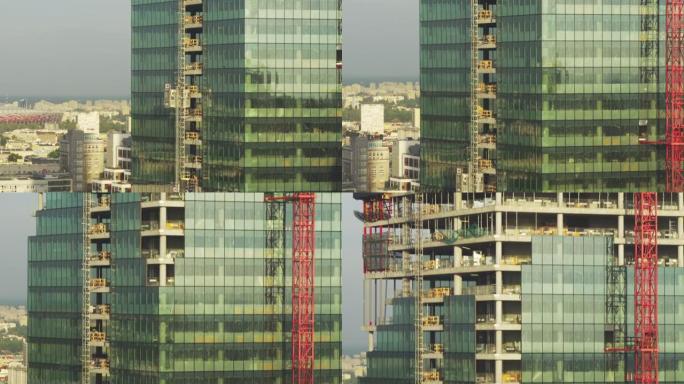 正在建造的玻璃摩天大楼反射着蓝天。无人机的观点