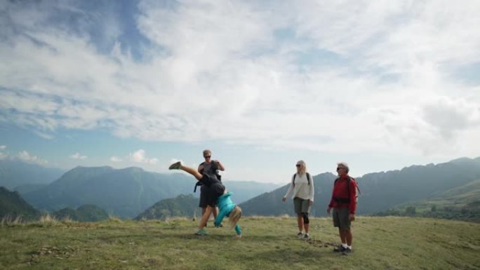 女人在山上与家人徒步旅行时站着