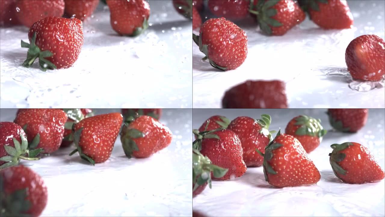 草莓在白色背景上滚动。慢动作