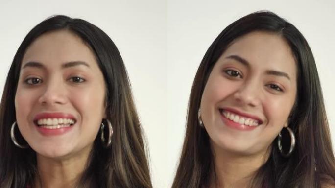 开朗的亚洲女人看着镜头带着牙齿微笑