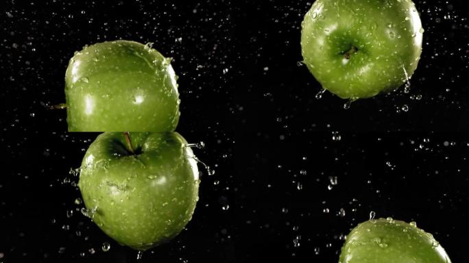 黑色背景下的绿色苹果在慢动作中的飞行