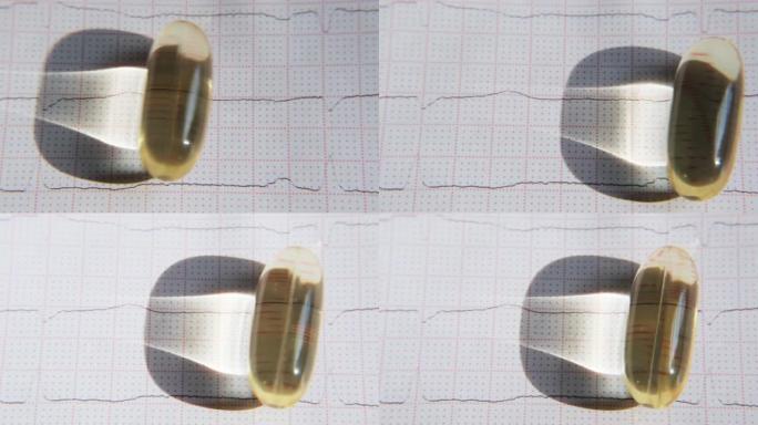 ECG背景上的omega-3胶囊特写滚动。健康心脏概念。
