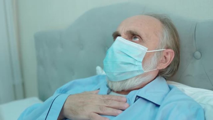 老人戴着防护口罩咳嗽，呼吸急促，冠状病毒症状