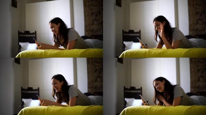 年轻女子视频聊天，手机躺在床上