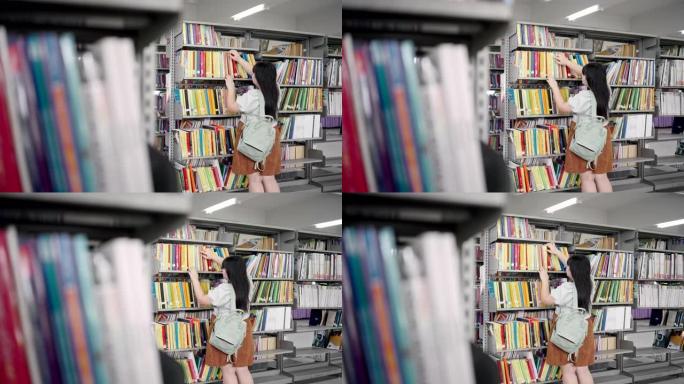 女学生在图书馆寻找和搜索书籍。